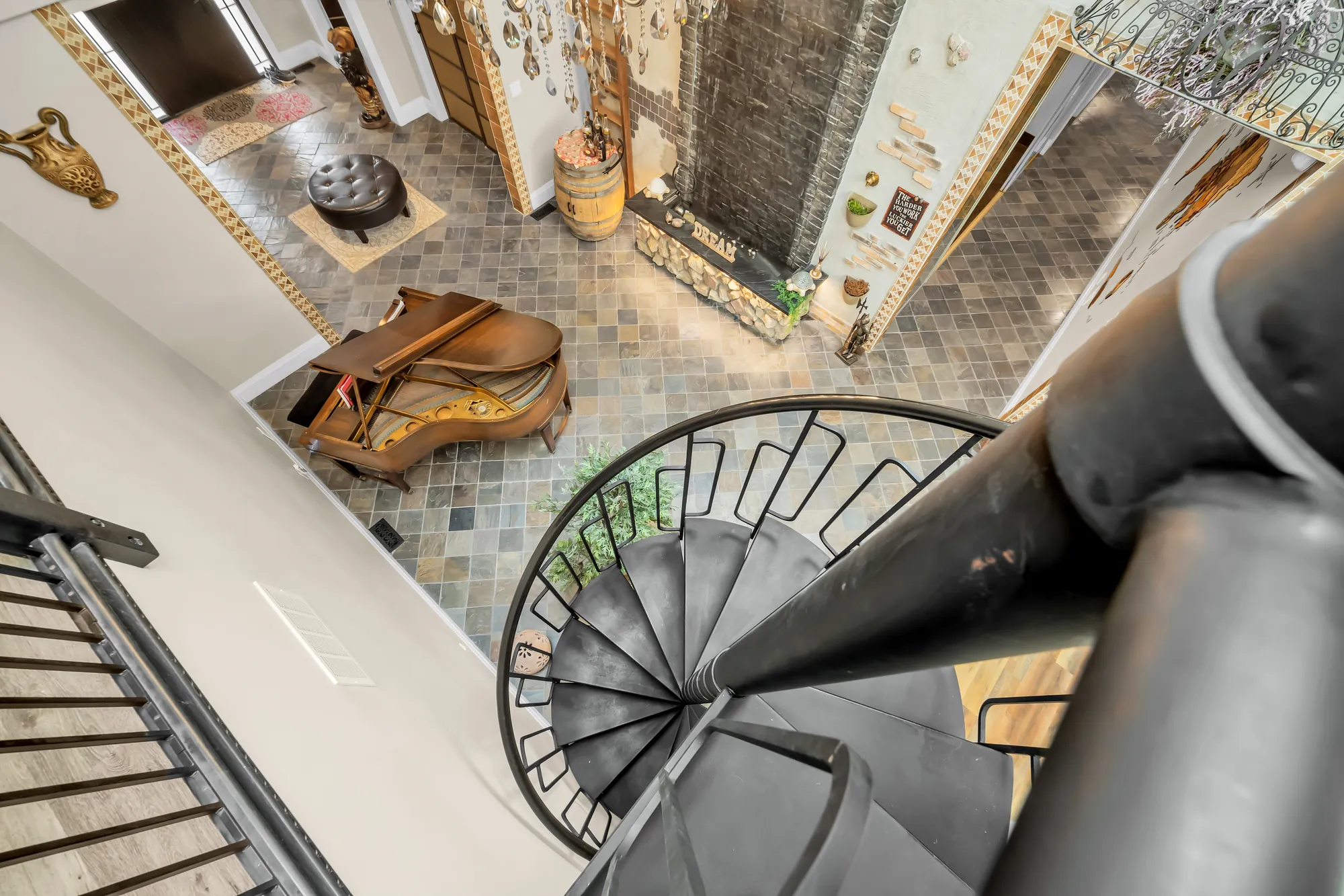 Looking down the spiral stair to the piano and the slate floor